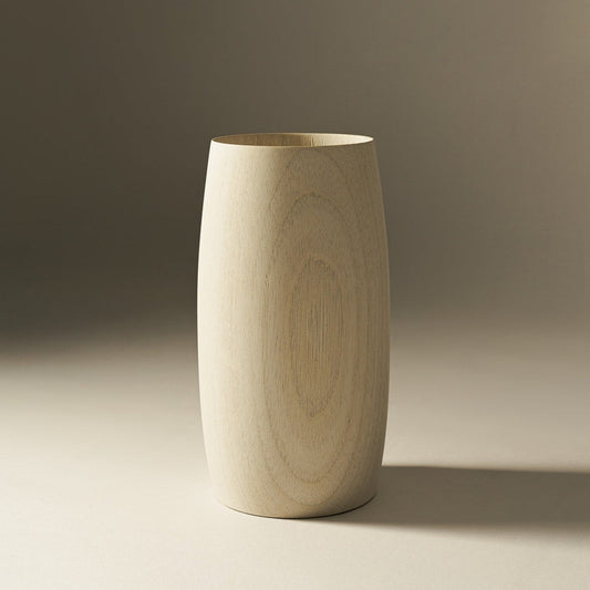 A beige, cylindrical ceramic vase with a subtle, natural wood finish.