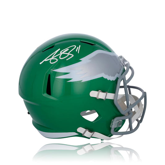 Green football helmet with eagle logo and signature on a white background