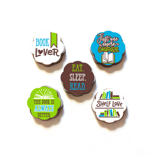 A collection of chocolates with various book-themed phrases on the wrappers, such as 'Book Lover', 'Eat, Sleep, Read', and 'Shelf Love'.
