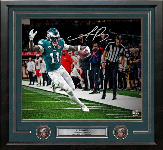 Framed photograph of a football player in action with a signature on the image.