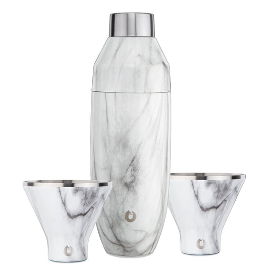 Marble-patterned cocktail shaker and two glasses on a white background