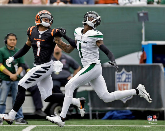Two football players in action on a field with a visible NFL logo.