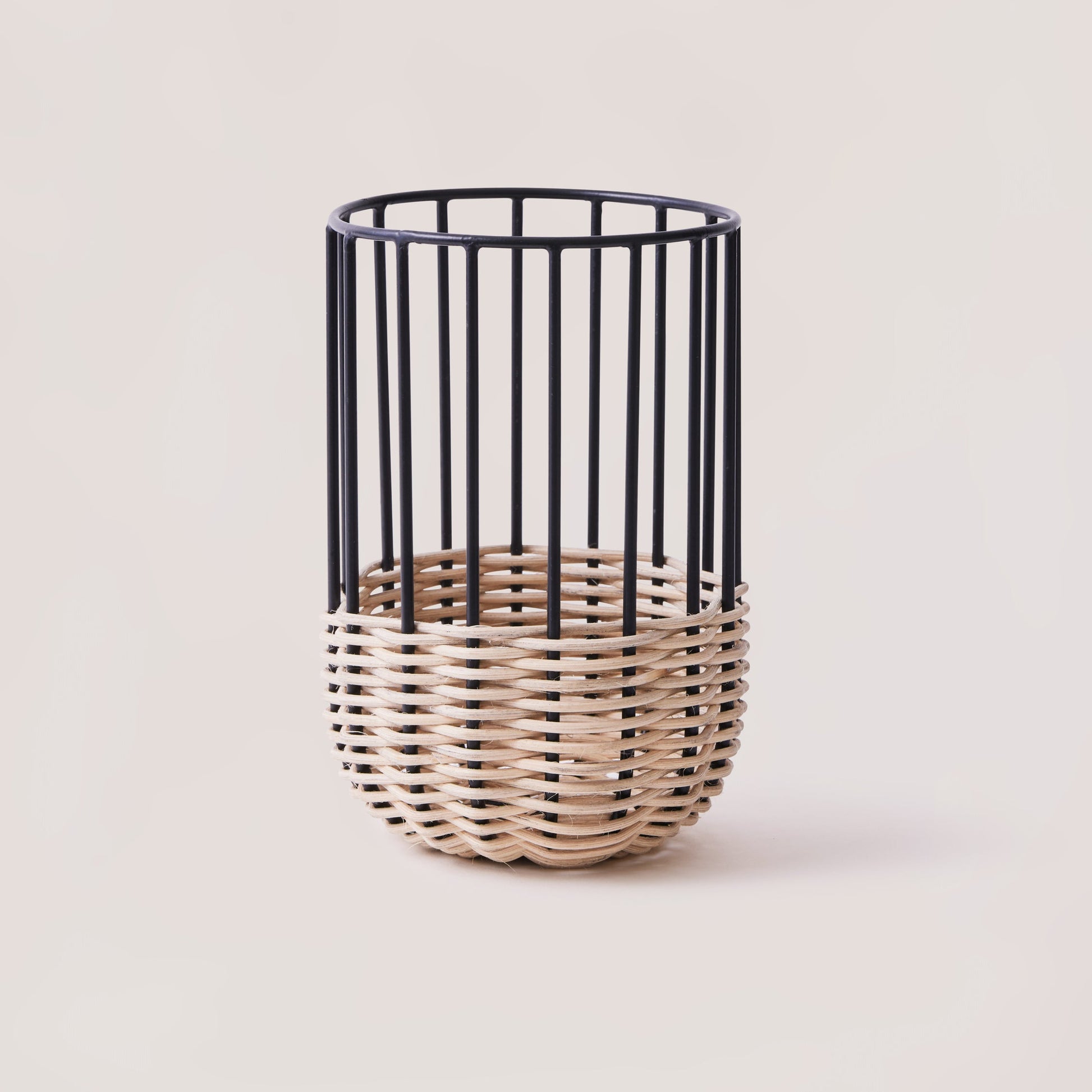 A medium-sized kitchen utensil holder with a minimal design, featuring natural rattan on a powder-coated iron frame.