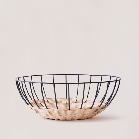 A woven rattan basket with a powder-coated iron frame, featuring a open, airy design, displayed against a neutral background.