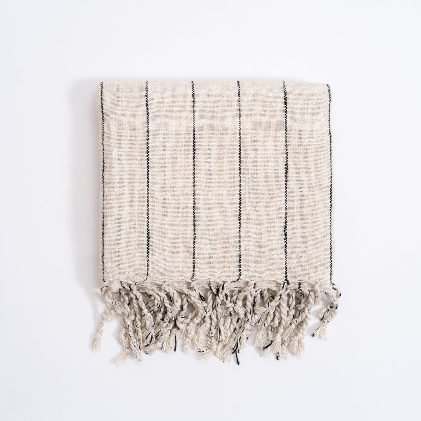 A striped Turkish hand towel in beige and gray, with fringed edges, displayed on a white background.