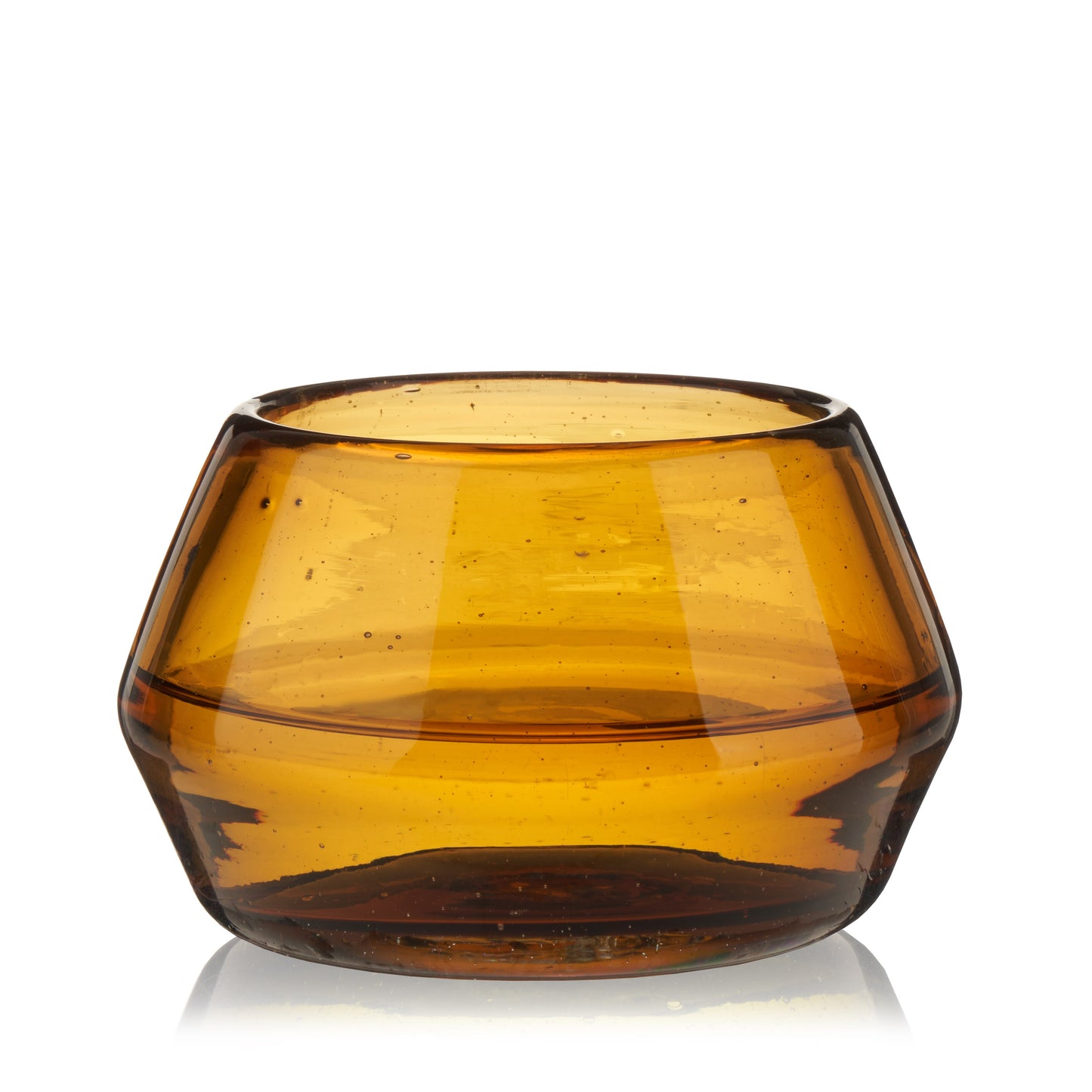Amber tequila copita glass on rustic wood table