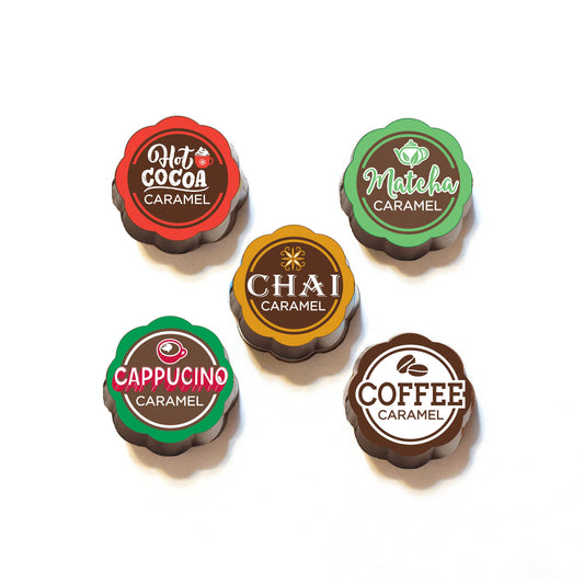 A set of chocolate covered caramels with various flavors indicated by color and label, including coffee, capuccino, chai, hot chocolate, and matcha.